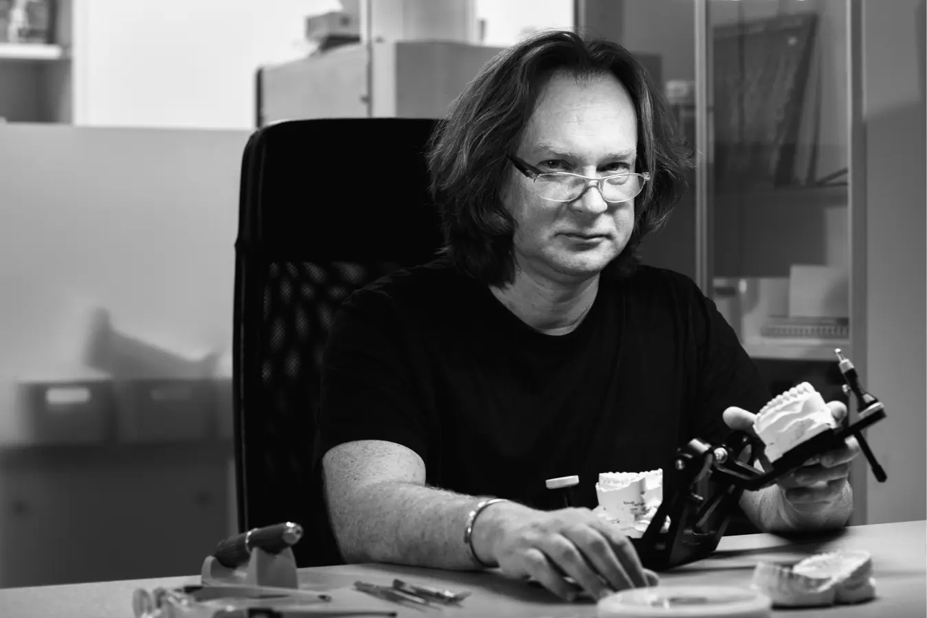 man_showing_tooth_model