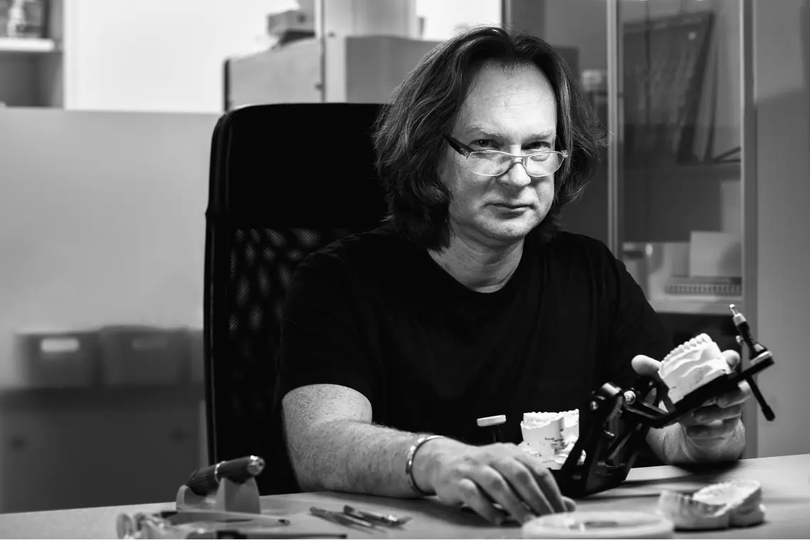 man_showing_tooth_model